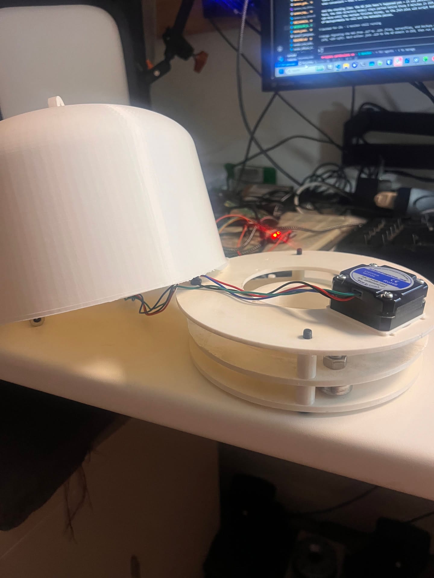 The printed top drive with its stepper motor sitting on the bench